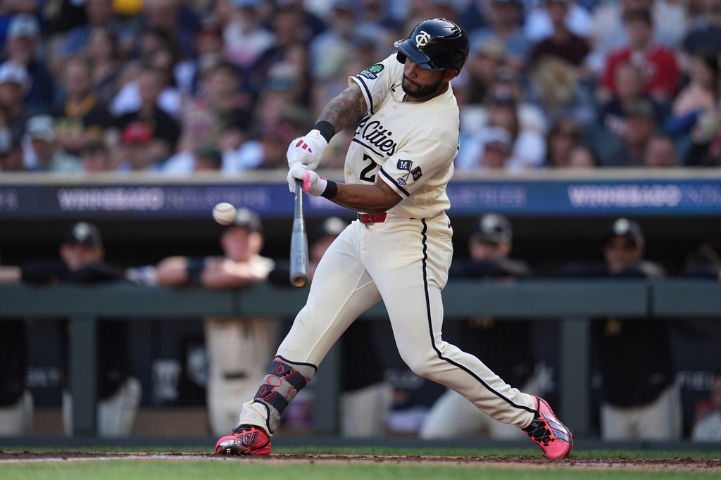 Minnesota Twins' Emmanuel Rodriguez hits a solo home run for his first-career hit during his MLB debut in the third inning of a baseball game Saturday, Sept. 12, 2026, in Minneapolis. (AP Photo/Abbie Parr)