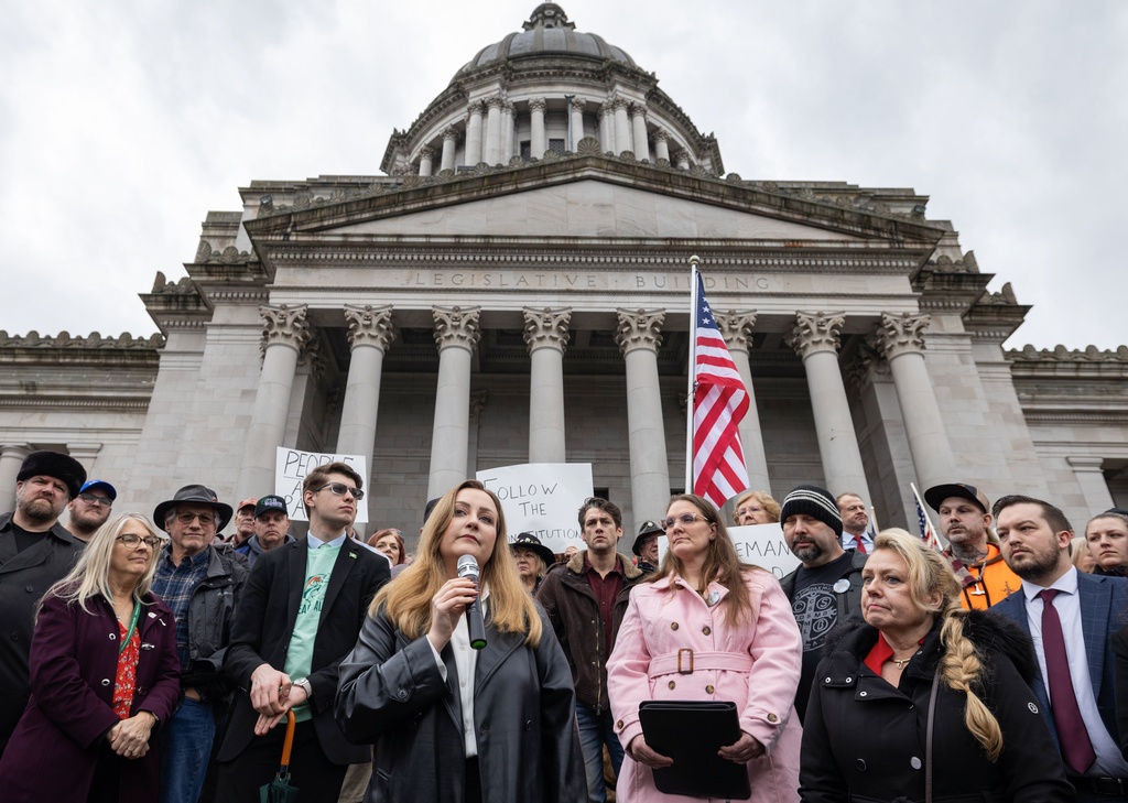 FILE - Political podcast host Brandi Kruse, foreground, speaks during a rally to urge Democratic lawmakers to hold hearings to consider GOP initiatives Jan. 31, 2024 in Olympia, Wash. (Ken Lambert/The Seattle Times via AP, File)