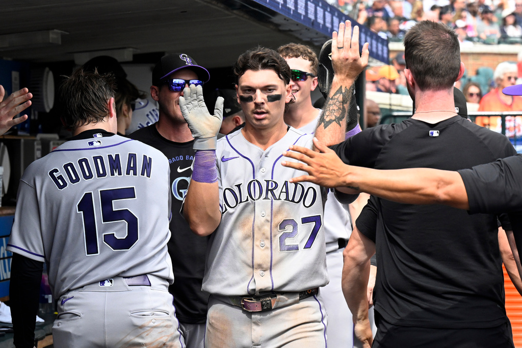 Colorado Rockies' Jordan Beck (27) is congratulated after scoring a run during the fourth inning of a baseball game against the Detroit Tigers, Saturday, Sept. 12, 2026, in Detroit. (AP Photo/Jose Juarez)