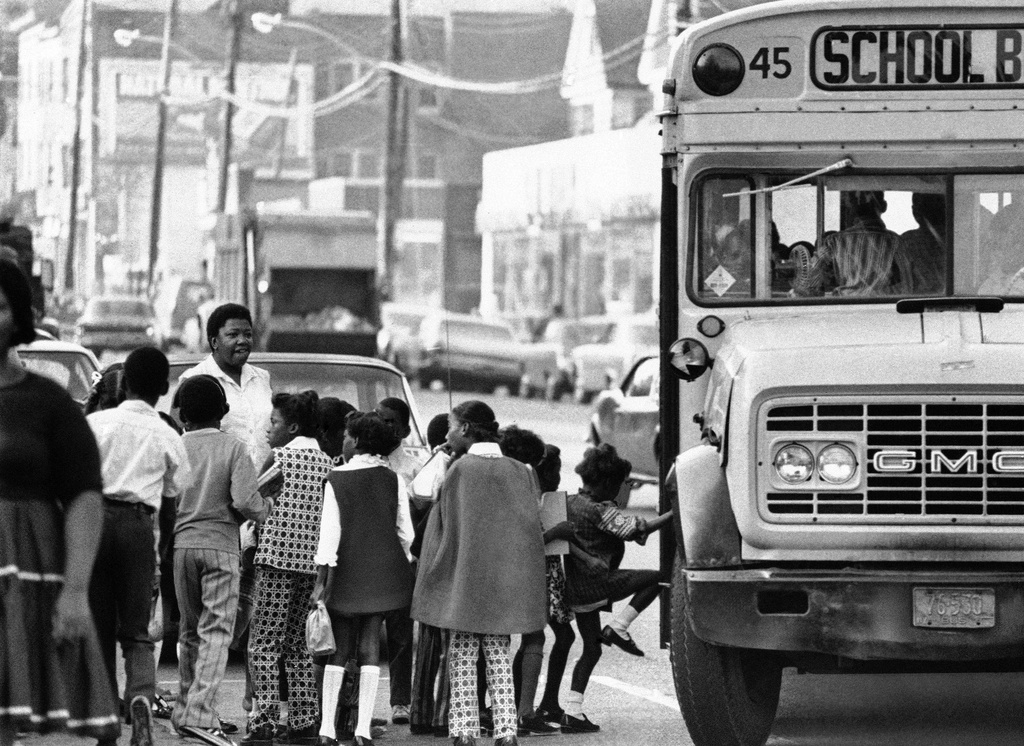 FILE - Children board buses in the center city of an unknown location to go to outlying schools on Dec. 10, 1971. (AP Photo, File)