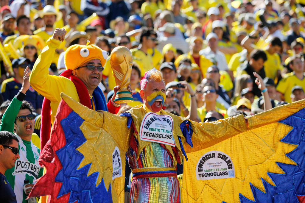 FILE - Colombian soccer fans cheer before a World Cup qualifying soccer game between Ecuador and Colombia in Quito, Ecuador, June 10, 2012. (AP Photo/Dolores Ochoa, File)
