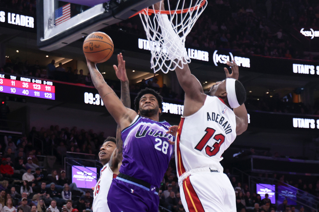 Utah Jazz forward Brice Sensabaugh (28) goes to the basket against Miami Heat center Bam Adebayo (13) during the second half of an NBA basketball game, Saturday, Jan. 24, 2026, in Salt Lake City. (AP Photo/Rob Gray)