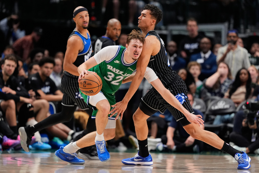 Dallas Mavericks forward Cooper Flagg (32) works to the basket against Orlando Magic forward Tristan da Silva, right, in the second half of an NBA basketball game Friday, April 3, 2026, in Dallas. (AP Photo/Tony Gutierrez)