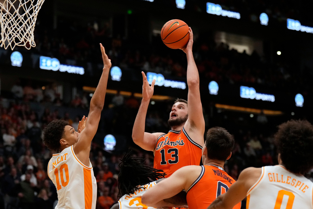 Illinois center Tomislav Ivisic (13) shoots the ball over Tennessee forward Nate Ament (10) during the first half of an NCAA college basketball game Saturday, Dec. 6, 2025, in Nashville, Tenn. (AP Photo/George Walker IV)