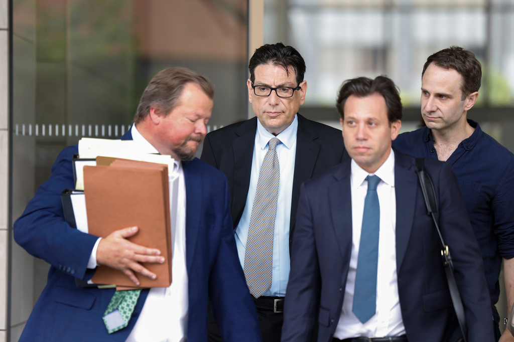 Erik Fleming, second from left, departs federal court with defense lawyers Robert Dugdale, left, and Jeffrey Chemerinsky, second from right, after being sentenced in connection with the ketamine overdose death of actor Matthew Perry, on Wednesday, May 13, 2026, in Los Angeles. (AP Photo/Caroline Brehman)