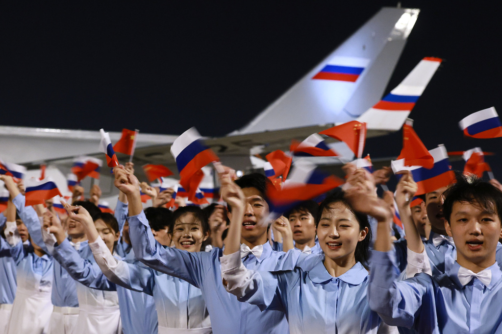 Chinese youth greet Russian President Vladimir Putin as he arrives in Beijing, Tuesday, May 19, 2026, for a two day visit to meet President Xi Jinping. (Vladimir Smirnov, Sputnik, Kremlin Pool Photo via AP)