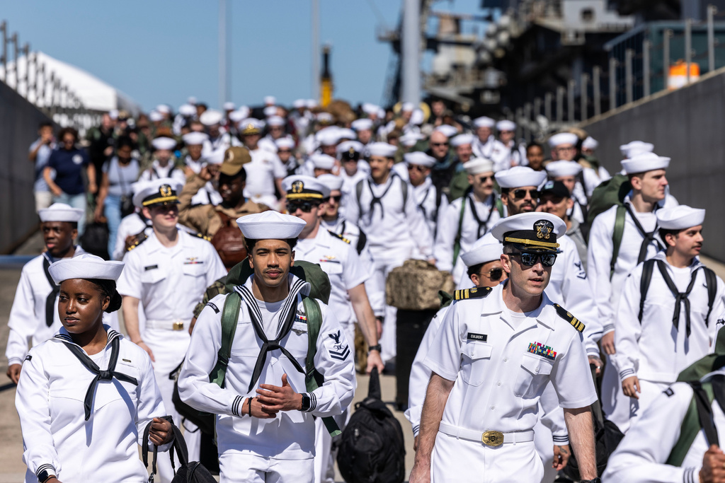 Sailors walk off of Pier 11 to find their loved ones after disembarking from the USS Gerald R. Ford at Naval Station Norfolk in Norfolk, Va. on Saturday, May 16, 2026, following an 11 month deployment. (Kendall Warner/The Virginian-Pilot via AP)