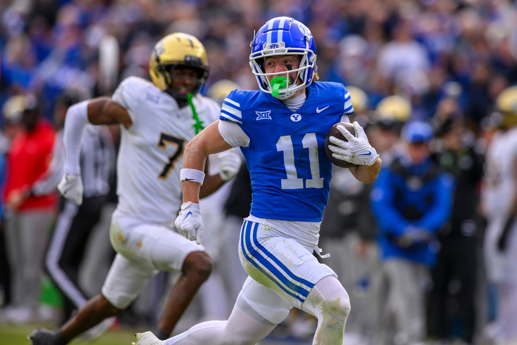 FILE - BYU wide receiver Parker Kingston (11) runs the ball in for a touchdown during the second half an NCAA college football game against UCF, Nov. 29, 2025, in Provo, Utah. (AP Photo/Tyler Tate, File)