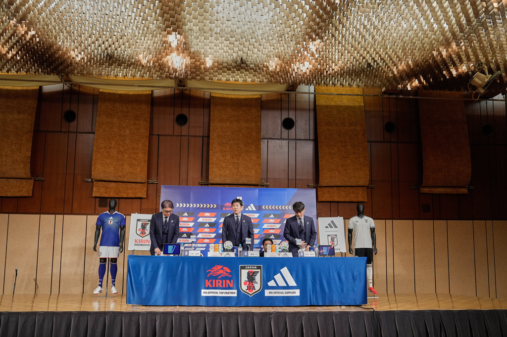 Masakuni Yamamoto, left, national team director, Hajime Moriyasu, center, head coach of Japan's national soccer team, and Tsuneyasu Miyamoto, right, president of the Japan Football Association, prepare to attend a news conference announcing Japan's squad for the 2026 FIFA World Cup Friday, May 15, 2026, in Tokyo. (AP Photo/Eugene Hoshiko)