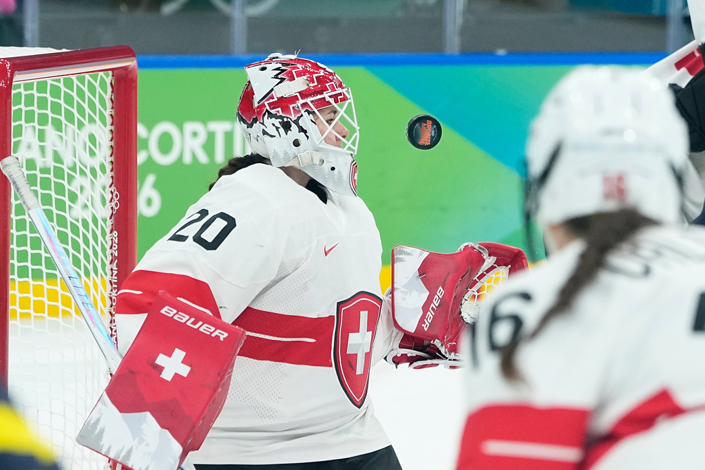Switzerland's Andrea Braendli (20) eyes the puck during a women's ice hockey bronze medal game between Switzerland and Sweden at the 2026 Winter Olympics, in Milan, Italy, Thursday, Feb. 19, 2026. (AP Photo/Petr David Josek)