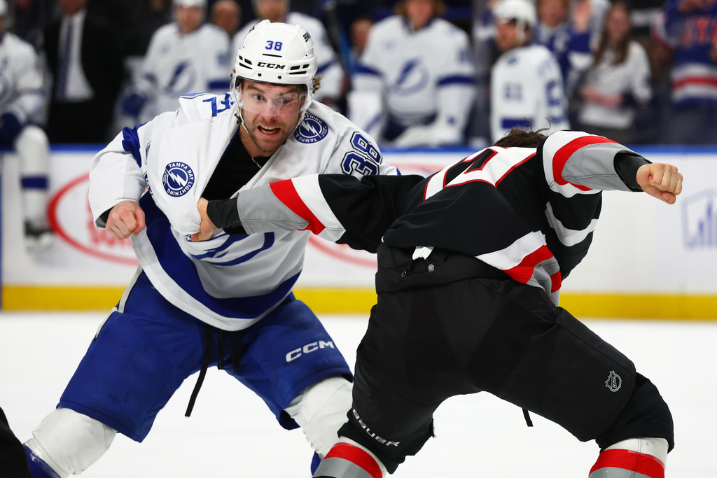 Tampa Bay Lightning left wing Brandon Hagel (38) and Buffalo Sabres center Peyton Krebs fight during the first period of an NHL hockey game, Sunday, March 8, 2026, in Buffalo, N.Y. (AP Photo/Jeffrey T. Barnes)