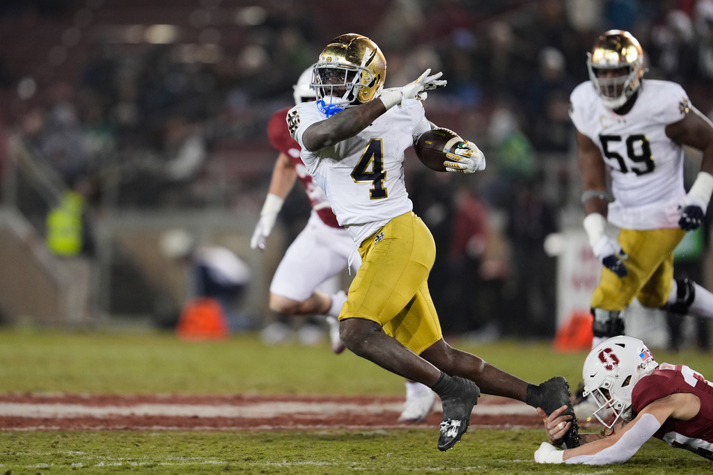 Notre Dame running back Jeremiyah Love (4) is tackled by Stanford safety Charlie Eckhardt (39) during the second half of an NCAA college football game, Saturday, Nov. 29, 2025, in Stanford, Calif. (AP Photo/Godofredo A. Vásquez)