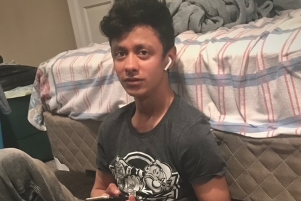 This photo provided by Henry Castro shows Josué Castro Rivera holding a cell phone in Virginia Beach, Va., in April 2021. (Henry Castro via AP)