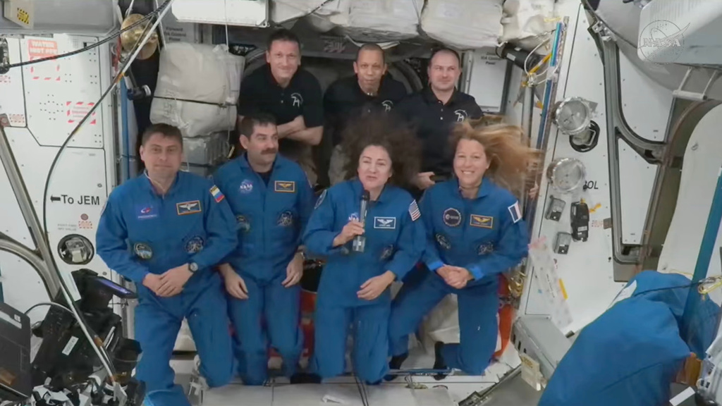 In this image from video provided by NASA, foreground from left, Russian Andrei Fedyaev, Americans Jack Hathaway and Jessica Meir and France’s Sophie Adenot, gather with, background from left, Russian Sergey Kud-Sverchkov, American Christopher Williams and Russian Sergei Mikayev, after a new crew entered the International Space Station on Saturday, Feb. 14, 2026. (NASA via AP)