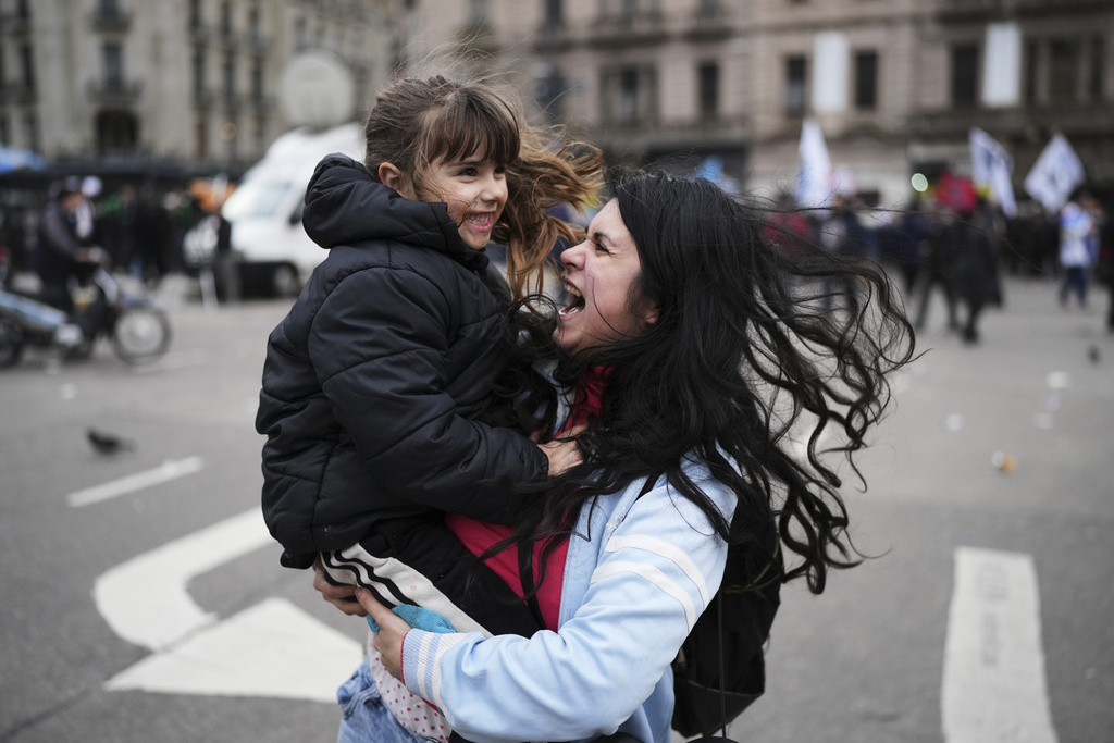 Brenda Robalo celebrates with her daughter Catalina after deputies rejected President Javier Milei's veto to expand protections for people with disabilities, in Buenos Aires, Argentina, Wednesday, Aug. 20, 2025. (AP Photo/Natacha Pisarenko)