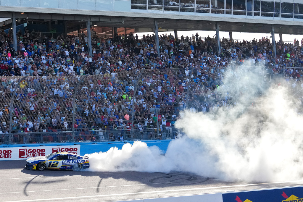 Ryan Blaney (12) does a burnout after winning a NASCAR Cup Series auto race at Phoenix Raceway, Sunday, March 8, 2026, in Avondale, Ariz. (AP Photo/Darryl Webb)