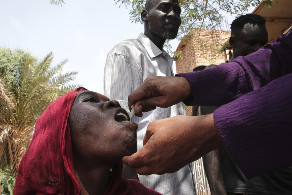 A Sudanese woman receives an oral cholera vaccine during a 10-day vaccination campaign conducted by health ministry workers in Khartoum, Sudan, Wednesday, Aug. 13, 2025. (AP Photo/Marwan Ali)