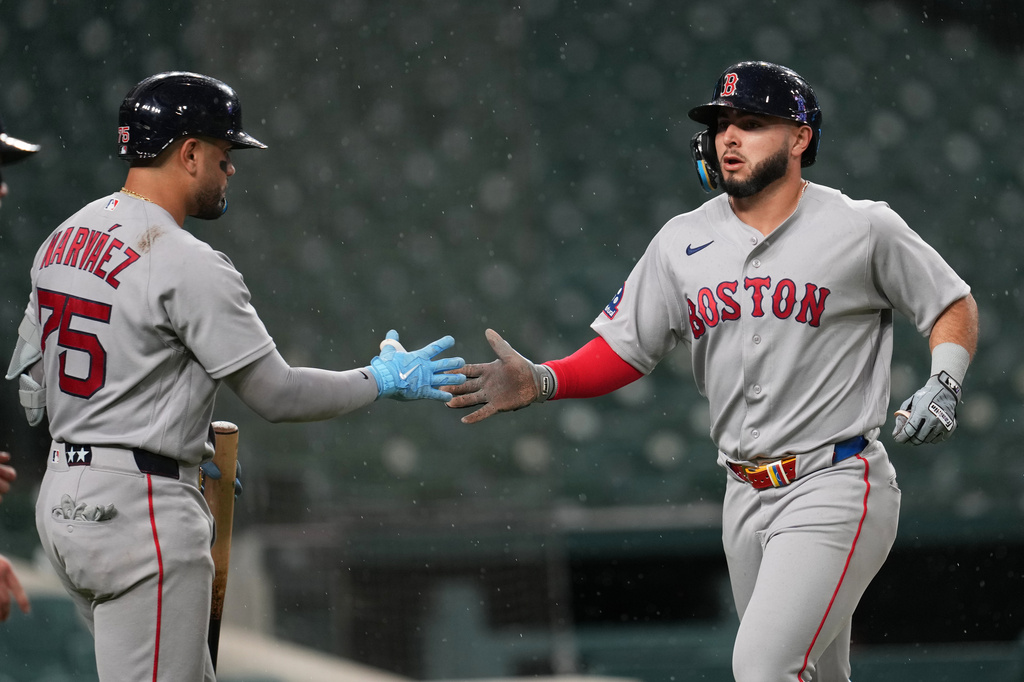 Boston Red Sox's Wilyer Abreu, right, celebrates scoring with Carlos Narváez (75) against the Detroit Tigers during the seventh inning of a baseball game Monday, May 4, 2026, in Detroit. (AP Photo/Paul Sancya)