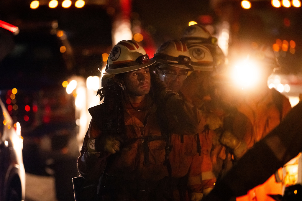 Inmate crews hike while battling the Sandy Fire Monday, May 18, 2026, in Simi Valley, Calif. (AP Photo/Ethan Swope)