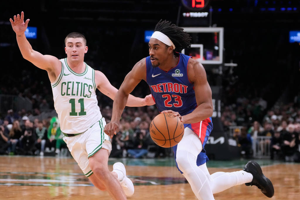 Detroit Pistons guard Jaden Ivey (23) drives to the basket against Boston Celtics guard Payton Pritchard (11) during the first half of an NBA basketball game, Monday, Dec. 15, 2025, in Boston. (AP Photo/Charles Krupa)