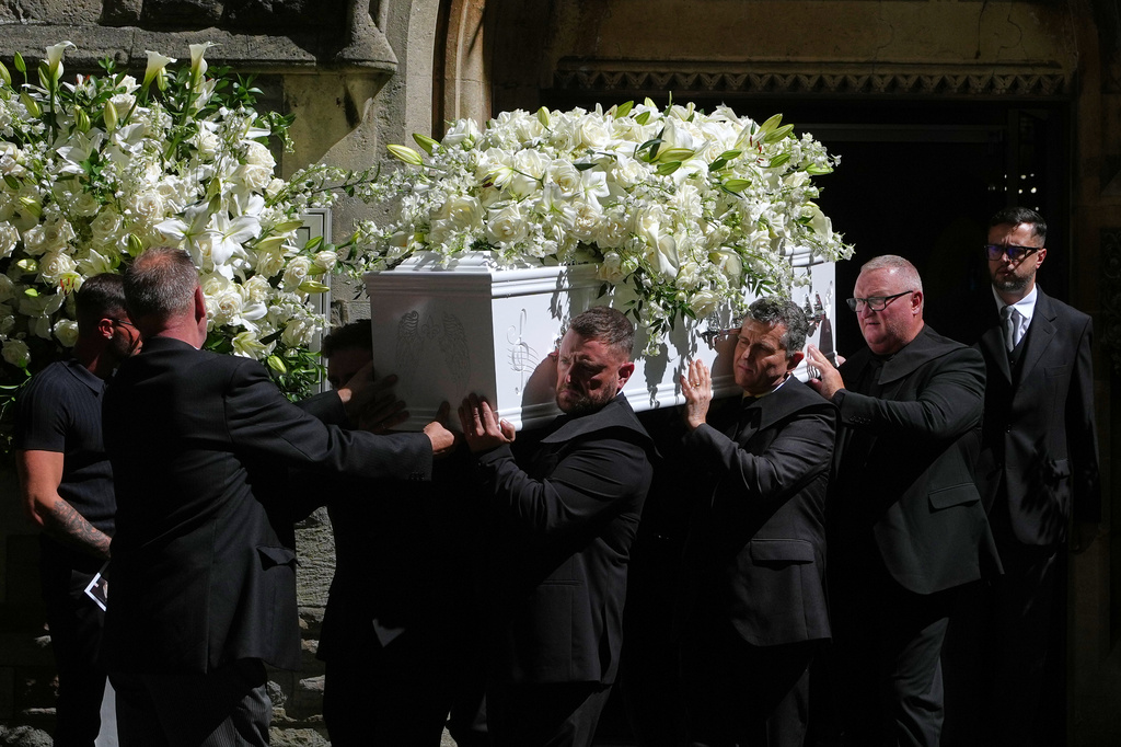 The coffin is taken from Swansea Minster following the funeral of Bonnie Tyler in Swansea, Wales, Monday, Aug. 17, 2026. (AP Photo/Alastair Grant)