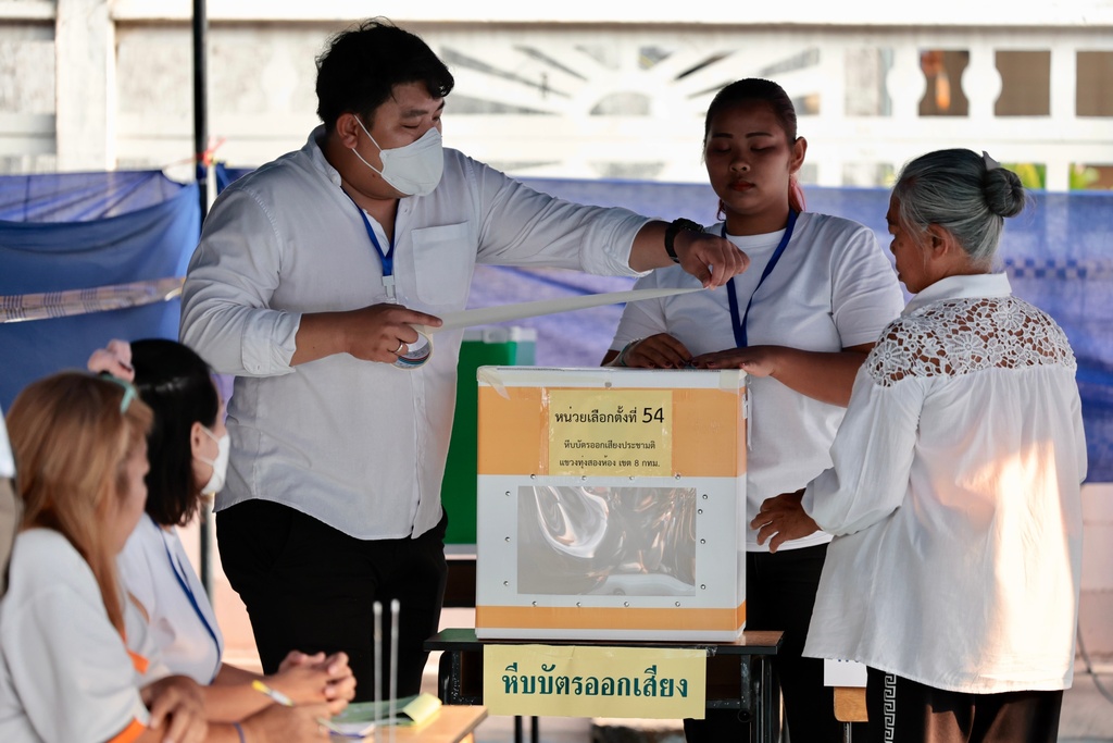 CORRECTS DATE TO 8, NOT 7 - Police officers and volunteers seal a ballot box at voting station before starting of Thailand's general election in Bangkok, Sunday, Feb. 8, 2026. (AP Photo/Wason Wanichakorn)