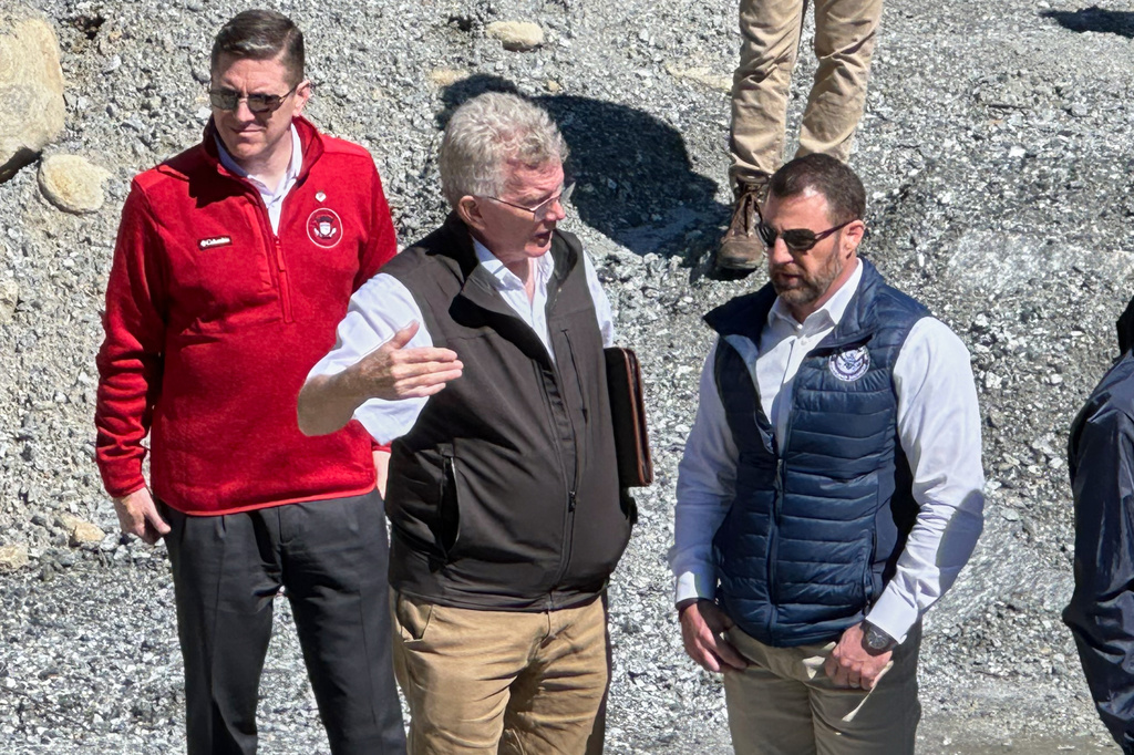 Homeland Security Secretary Markwayne Mullin, right, talks with Mayor Peter O'Leary, during a trip to survey damage caused by Hurricane Helene, Tuesday, April 7, 2026 in Chimney Rock, N.C. This is Mullin's first official trip since replacing Kristi Noem. (AP Photo Rebecca Santana)