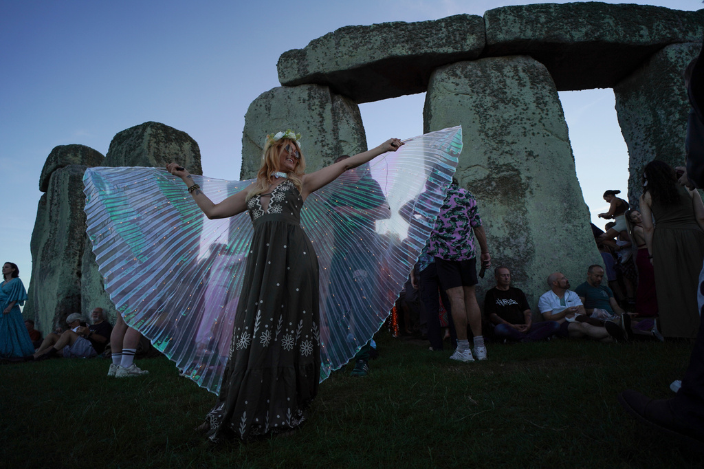 Revelers gather at the ancient stone circle Stonehenge to celebrate the summer solstice, the longest day of the year, near Salisbury, England, Saturday, June 20, 2026. (AP Photo/Alberto Pezzali)