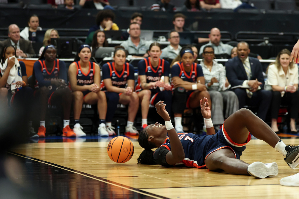 Virginia forward Tabitha Amanze, left, is injured driving to the basket with TCU center Clara Silva (17) on defense during the second half in the Sweet 16 of the NCAA college basketball tournament Saturday, March 28, 2026, in Sacramento, Calif. (AP Photo/Sara Nevis)