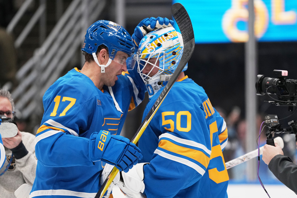 St. Louis Blues goaltender Jordan Binnington (50) and Cam Fowler (17) celebrate a victory over the Montreal Canadiens during the third period of an NHL hockey game Saturday, Jan. 3, 2026, in St. Louis. (AP Photo/Jeff Roberson)