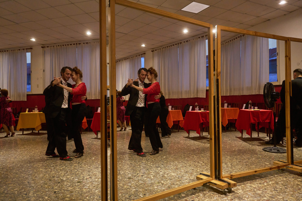 Antje Rickel, of France, right, dances with a professional tango dancer at the Che Che Tango Premium, where people can book guaranteed two‑hour dances with professional partners known as “Taxi Dancers," in Buenos Aires, Wednesday, Dec. 3, 2025. (AP Photo/Victor R. Caivano)