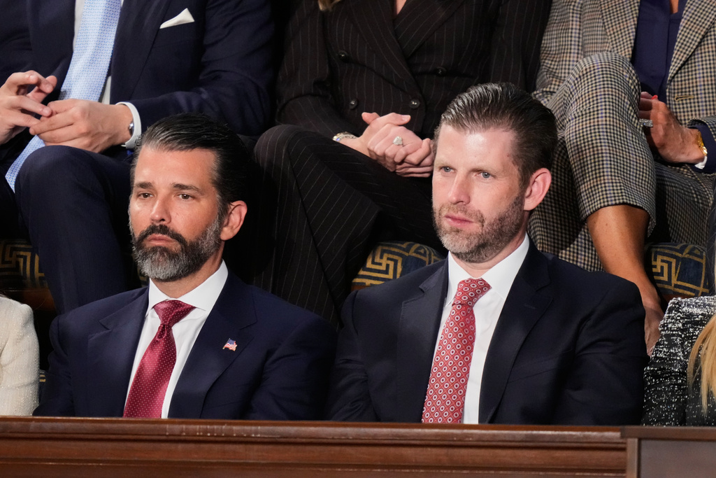 Donald Trump Jr. and Eric Trump listen to President Donald Trump's State of the Union address to a joint session of Congress in the House chamber at the U.S. Capitol in Washington, Tuesday, Feb. 24, 2026. (AP Photo/Alex Brandon)