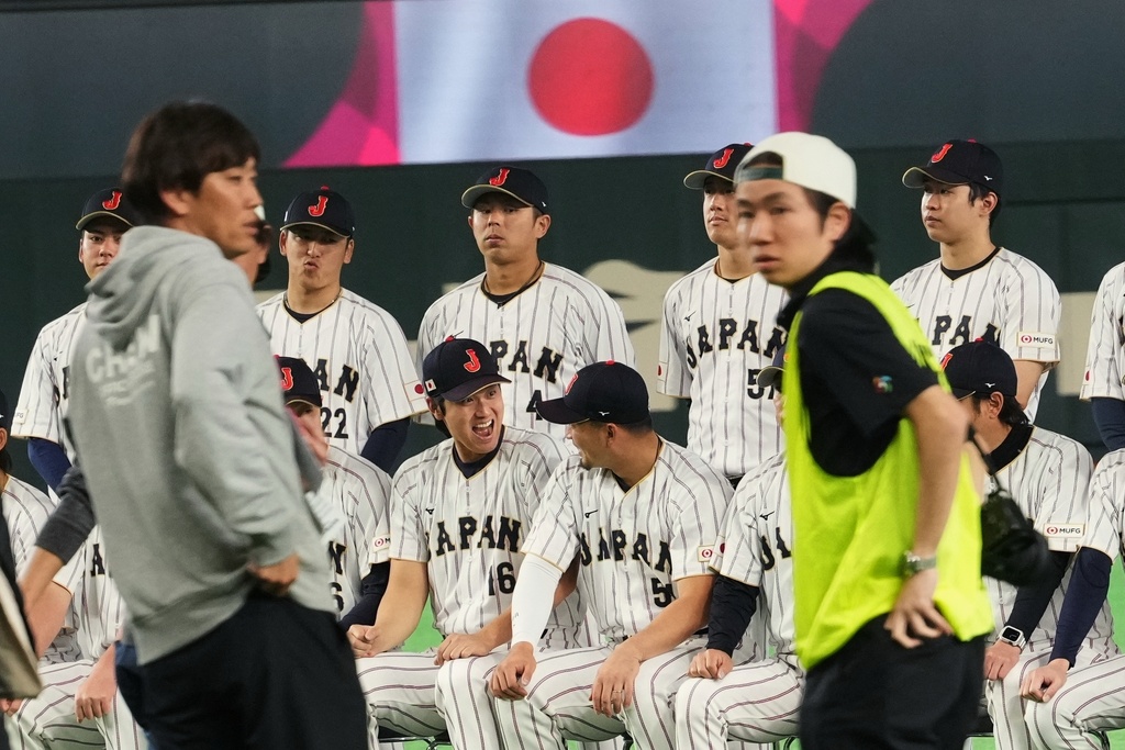 Japan's players including Shohei Ohtani, front center left, and Japan's Seiya Suzuki have a conversation as they wait for their group photos taken before their practice session in Tokyo, Wednesday, March 4, 2026, ahead of their World Baseball Classic games. (AP Photo/Hiro Komae)