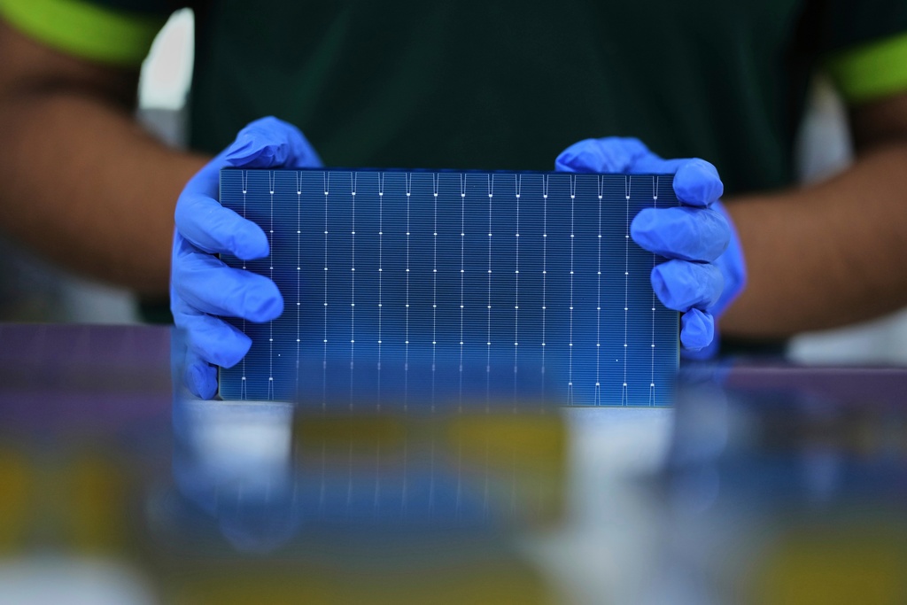 FILE - A worker stacks single solar cells at a ReNew manufacturing plant on the outskirts of Jaipur, India, Thursday, Aug. 21, 2025. (AP Photo/Manish Swarup, File)