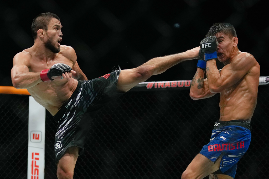 Russia's Umar Nurmagomedov, left, kicks Mario Bautista, of United States, during a bantamweight bout at the mixed martial arts UFC Fight Night in Abu Dhabi, United Arab Emirates, Saturday, Oct. 25, 2025. (AP Photo/Altaf Qadri)