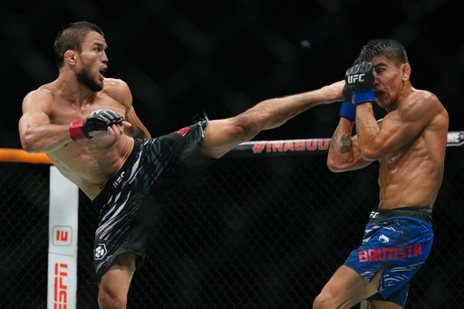 Russia's Umar Nurmagomedov, left, kicks Mario Bautista, of United States, during a bantamweight bout at the mixed martial arts UFC Fight Night in Abu Dhabi, United Arab Emirates, Saturday, Oct. 25, 2025. (AP Photo/Altaf Qadri) Russia's Umar Nurmagomedov, left, kicks Mario Bautista, of United States, during a bantamweight bout at the mixed martial arts UFC Fight Night in Abu Dhabi, United Arab Emirates, Saturday, Oct. 25, 2025. (AP Photo/Altaf Qadri)
