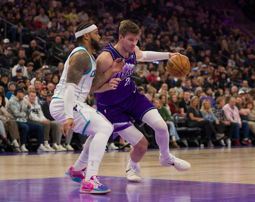 Utah Jazz center Kyle Filipowski (22) drives to the basket as Charlotte Hornets forward Miles Bridges, left, defends during the first half of an NBA basketball game, Saturday, Jan. 10, 2026, in Salt Lake City. (AP Photo/Bethany Baker)