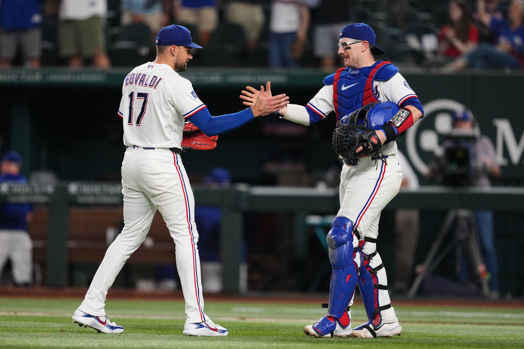 Texas Rangers pitcher Nathan Eovaldi (17) and catcher Danny Jansen, right, celebrate the team's win in a baseball game against the Boston Red Sox Wednesday, Sept. 16, 2026, in Arlington, Texas. (AP Photo/Tony Gutierrez)