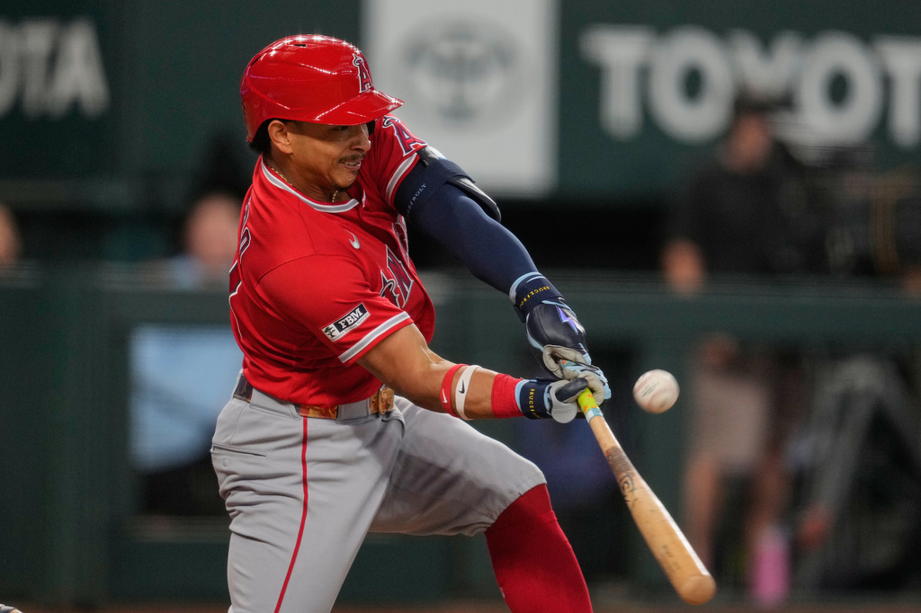Los Angeles Angels' Gustavo Campero connects for a run-scoring single in the eighth inning of a baseball game against the Texas Rangers Sunday, Aug. 23, 2026, in Arlington, Texas. (AP Photo/Tony Gutierrez)