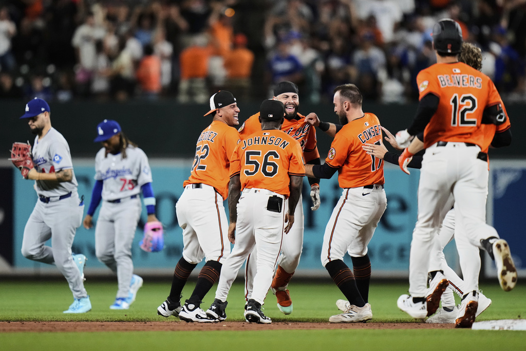Baltimore Orioles' Emmanuel Rivera, center, celebrates with teammates after hitting a walkoff single during the ninth inning of a baseball game against the Los Angeles Dodgers, Saturday, Sept. 6, 2025, in Baltimore. (AP Photo/Stephanie Scarbrough)