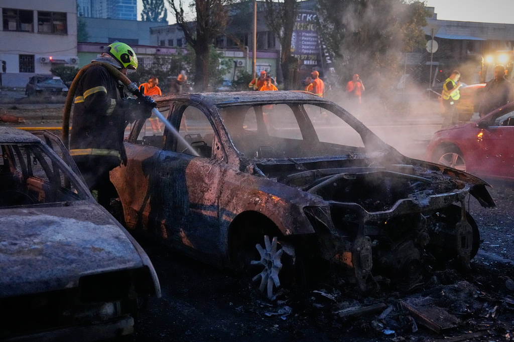 Emergency services personnel work to extinguish a fire following Russian missile attacks in Kyiv, Ukraine, Saturday, Aug. 1, 2026. (AP Photo/Efrem Lukatsky)