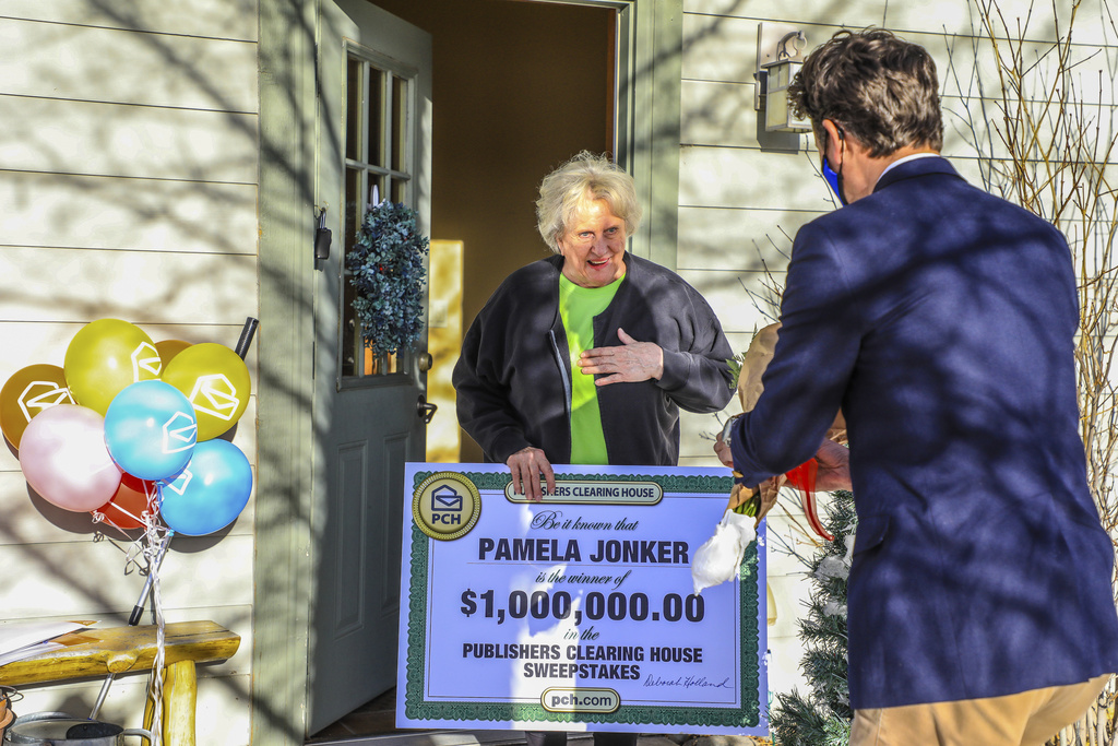 FILE - Pamela Jonker is presented with a $1 million check from the Publishers Clearing House Wednesday, Jan. 8, in Eagle, Colo.(Chris Dillmann/Vail Daily via AP, file)