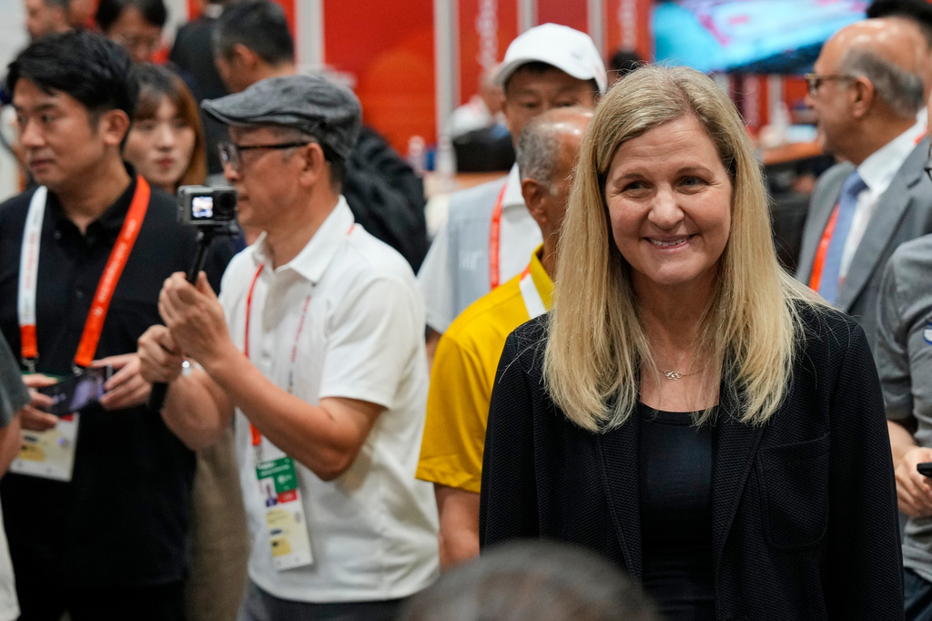 International Olympic Committee President, Kirsty Coventry, right, greets members of the media during a visit to the press centre at the Asian Games in Nagoya, Japan, Saturday, Sept. 19, 2026. (AP Photo/Dita Alangkara)