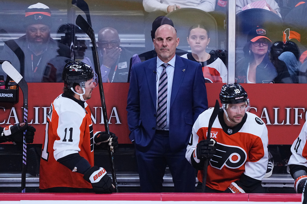 Philadelphia Flyers head coach Rick Tocchet, center, looks on from the bench during the first period of an NHL hockey game against the Florida Panthers, Monday, Oct. 13, 2025, in Philadelphia. (AP Photo/Matt Rourke)