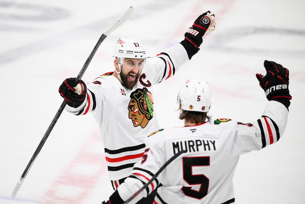 Chicago Blackhawks left wing Nick Foligno, left, celebrates his game-winning goal with defenseman Connor Murphy (5) in the shootout of an NHL hockey game against the Washington Capitals, Saturday, Jan. 3, 2026, in Washington. (AP Photo/Nick Wass)