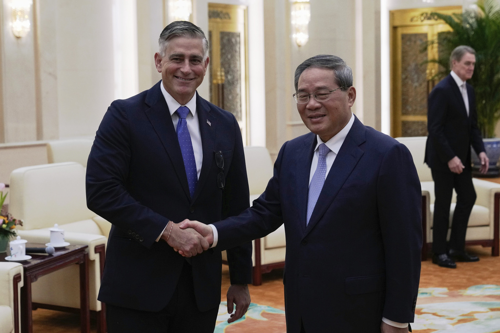 Michael Baumgartner, Republican member of House Foreign Affairs Committee, left, poses for a photo with Chinese Premier Li Qiang at the Great Hall of the People in Beijing, China, Sunday, Sept. 21, 2025. (AP Photo/Mahesh Kumar A., Pool)
