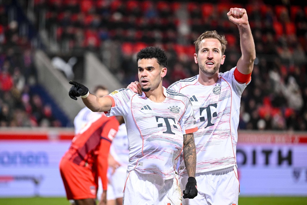 Bayern's Luis Díaz, left, celebrates with Harry Kane after scoring their side's third goal of the game during the Bundesliga soccer match between FC Heidenheim and Bayern Munich, in Heidenheim, Germany, Sunday Dec. 21, 2025. (Harry Langer/dpa via AP)