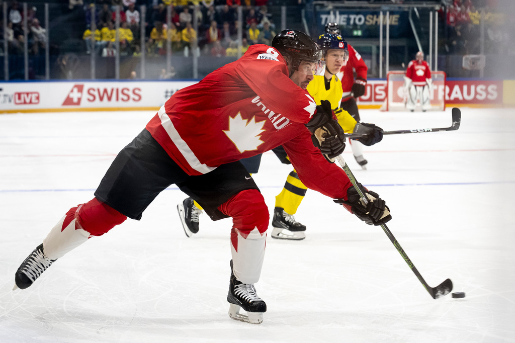 Canada's Sidney Crosby plays the puck during a Group B preliminary round game between Canada and Sweden at the men's ice hockey world championship in Fribourg, Switzerland, Friday, May 15, 2026. (Anthony Anex/Keystone via AP)