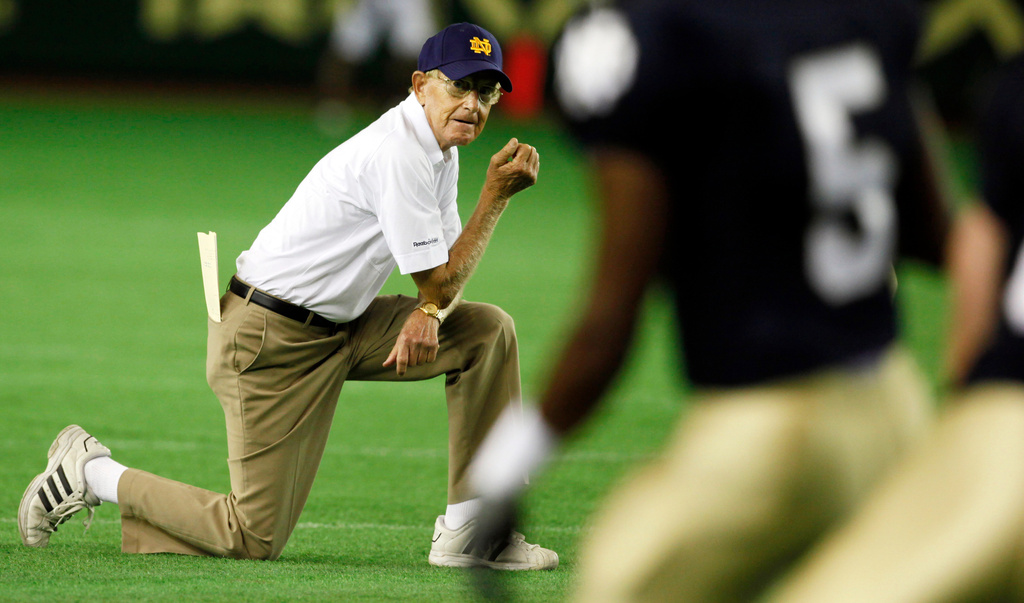 FILE - Notre Dame coach Lou Holtz watches his team workout before the start of their game against Japan's national American football team at the Notre Dame Japan Bowl in Tokyo Saturday, July 25, 2009. (AP Photo/Junji Kurokawa, File)