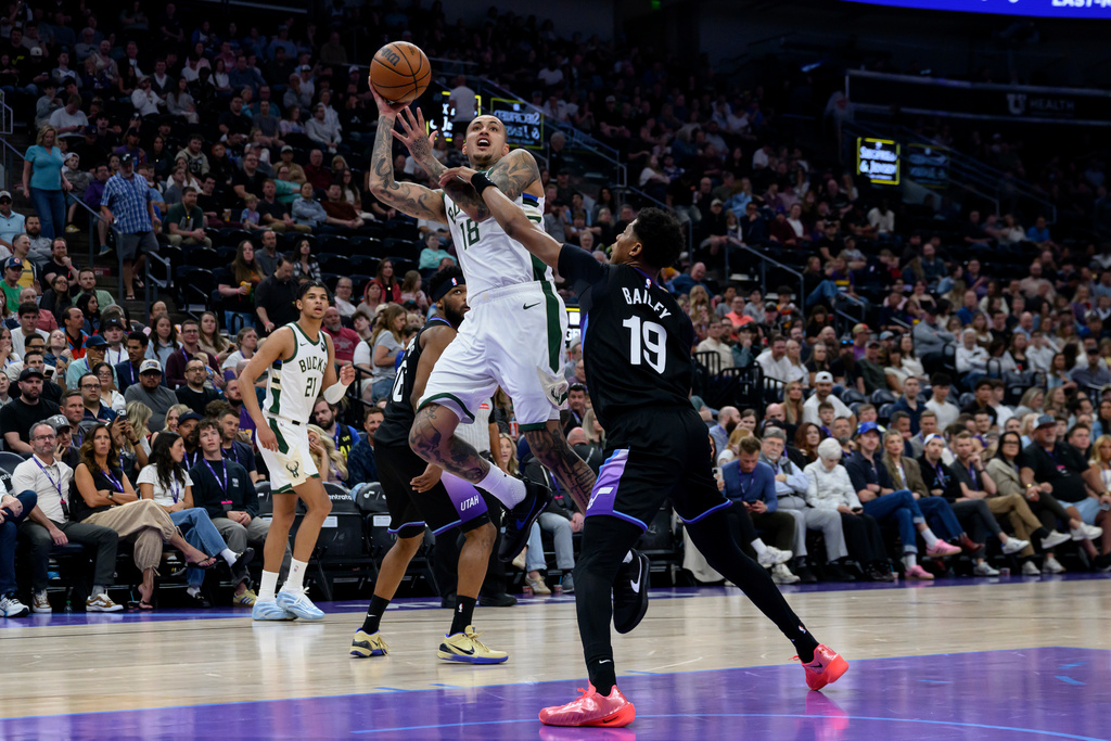 Milwaukee Bucks forward Kyle Kuzma (18) looks to shoot over Utah Jazz guard Ace Bailey (19) during the first half of an NBA basketball game Thursday, March 19, 2026, in Salt Lake City. (AP Photo/Tyler Tate)